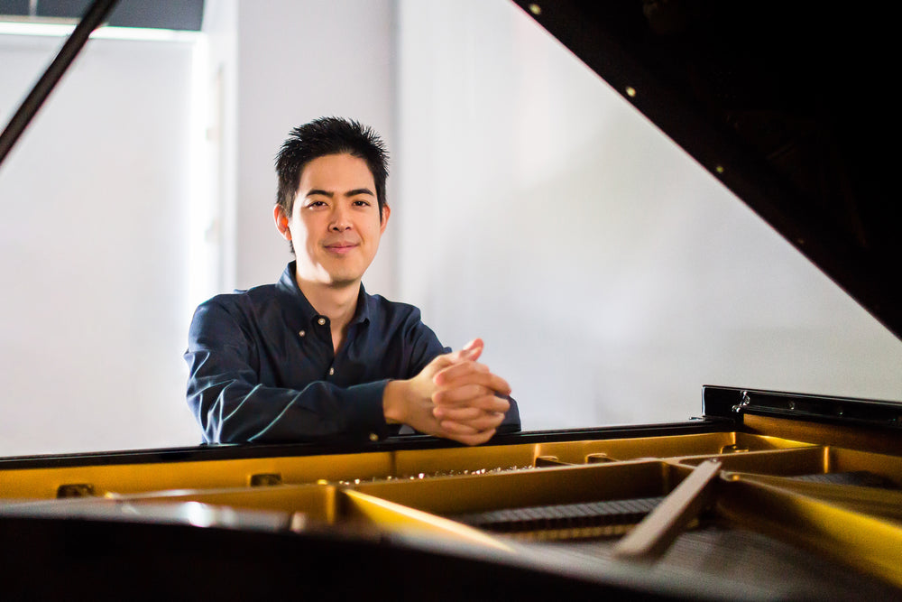 Grant Kondo seated at a grand piano
